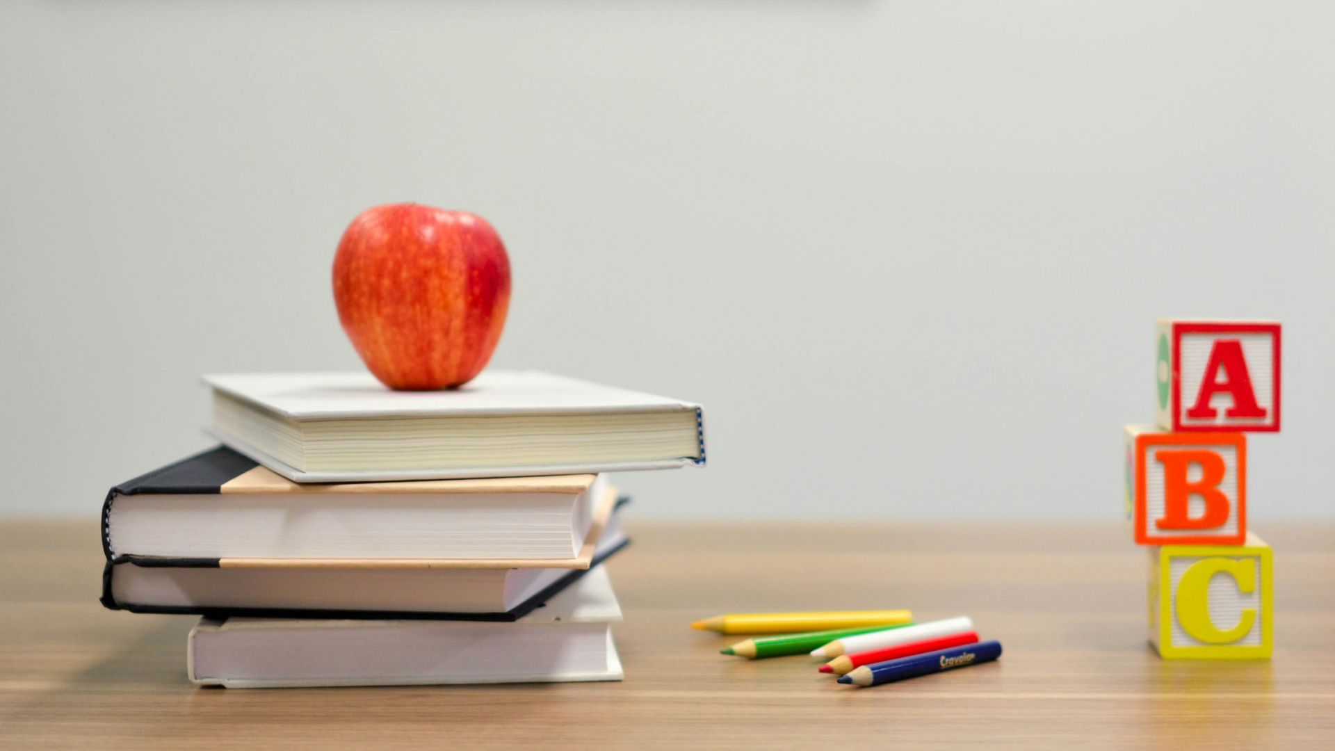 red apple fruit on four pyle books