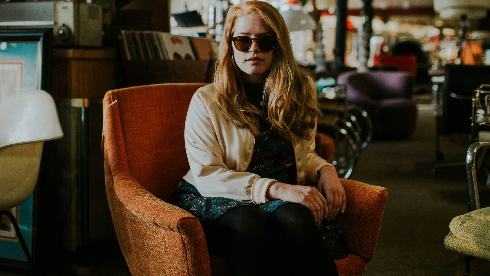 woman sitting on sofa wearing sunglasses
