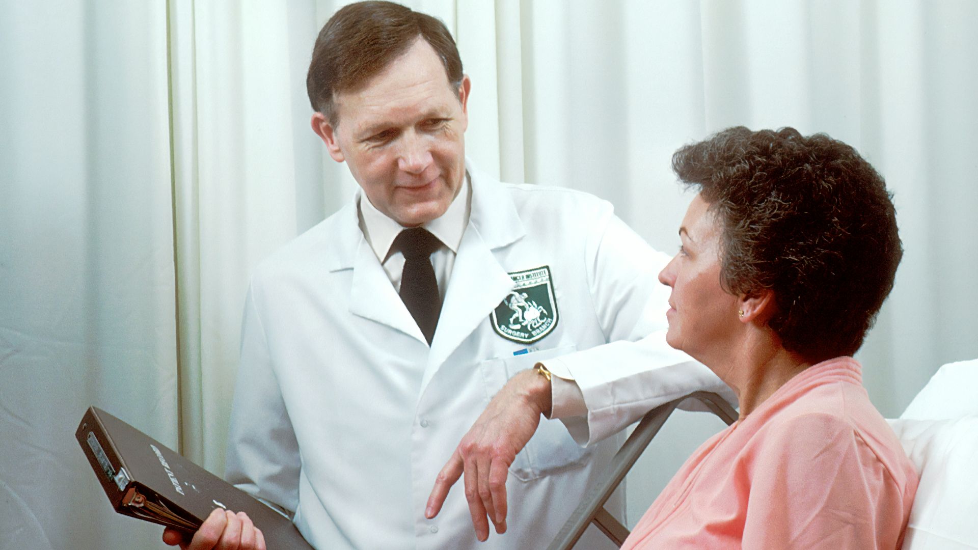 man in white button up shirt holding black tablet computer