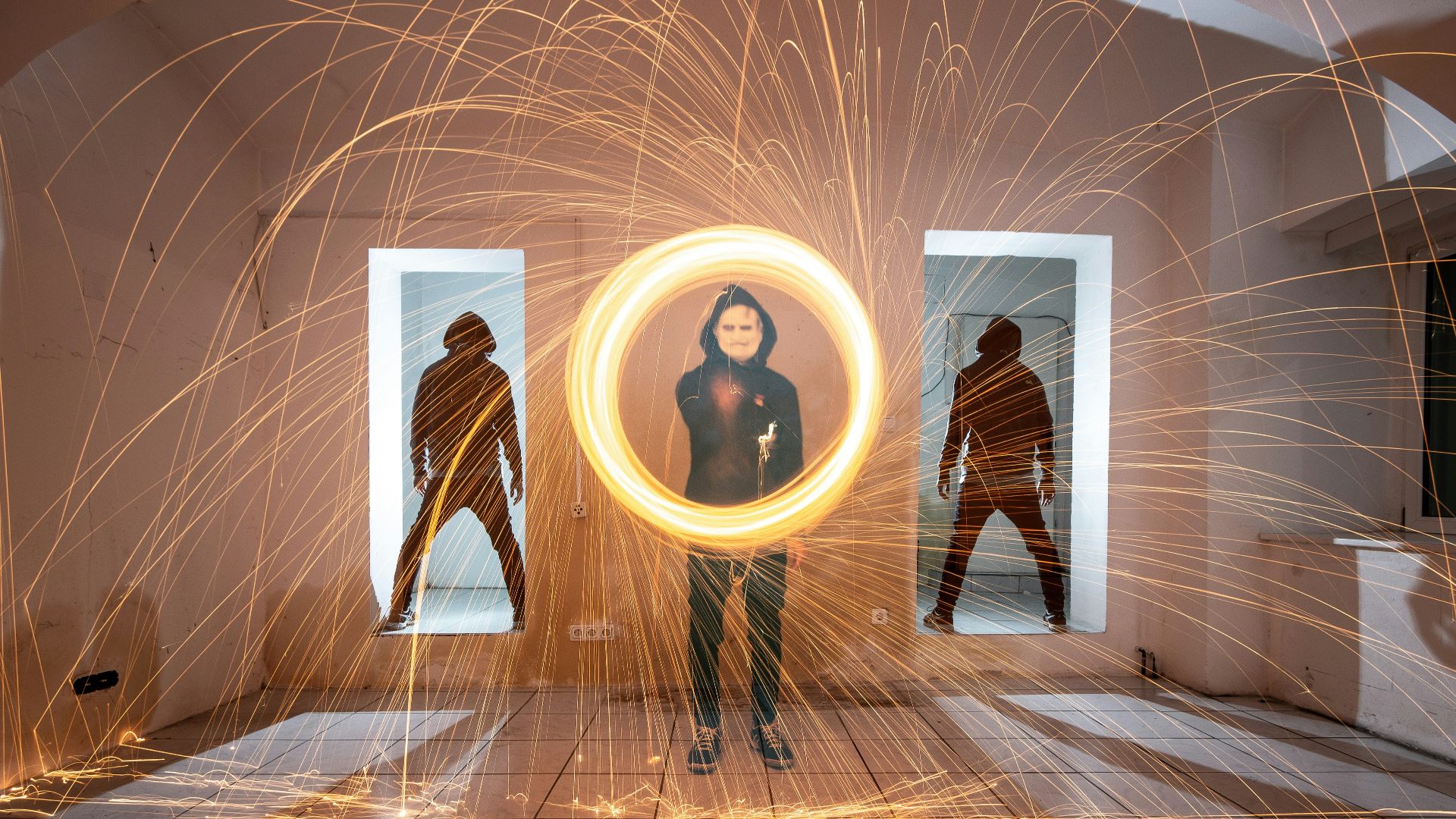 man holding fire sparks inside room