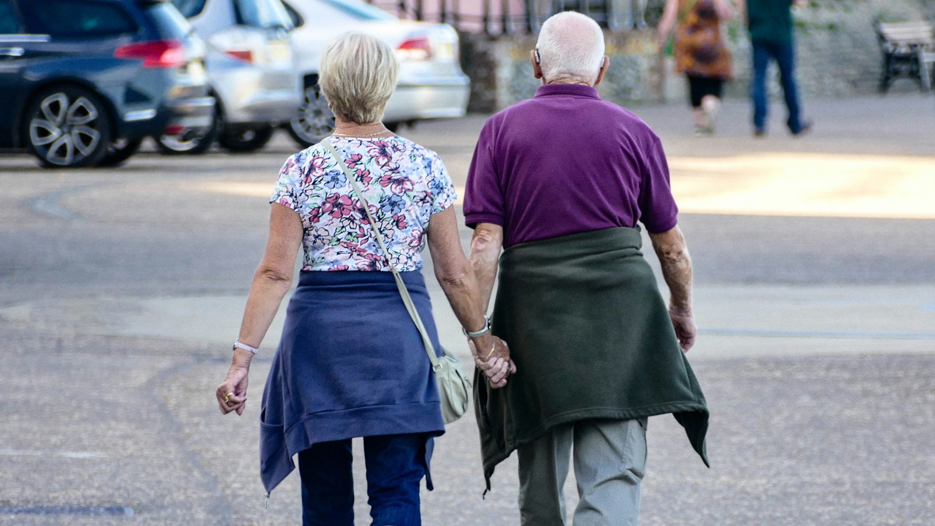 man and woman walking on the street during daytime