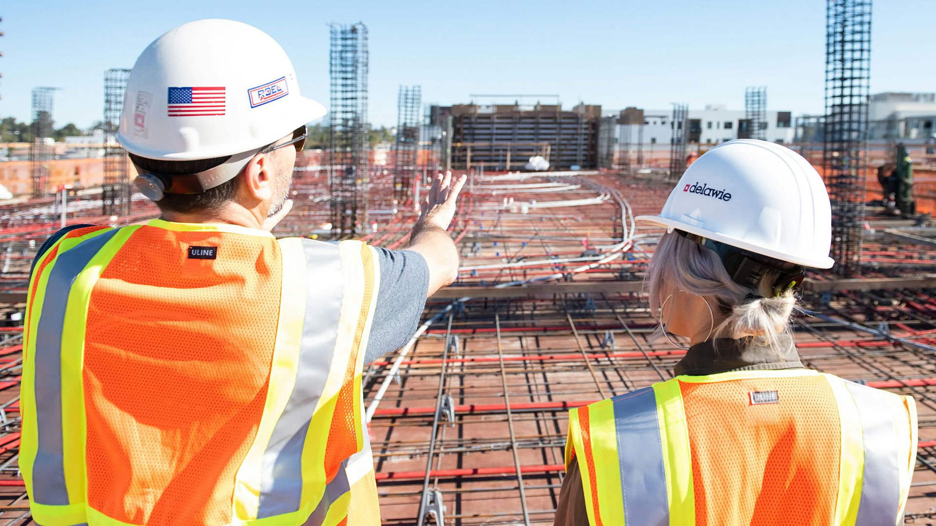man in white hard hat standing on brown wooden dock during daytime