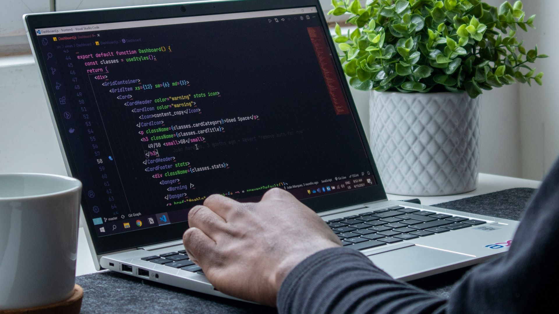 person using macbook pro on table