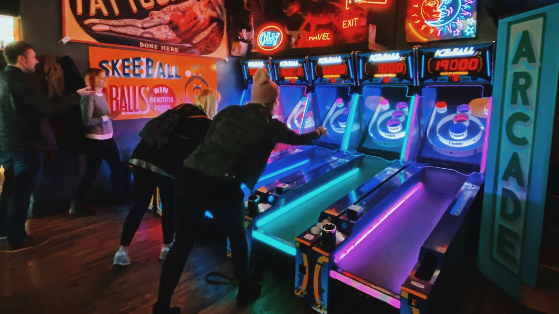 people playing arcade game inside room