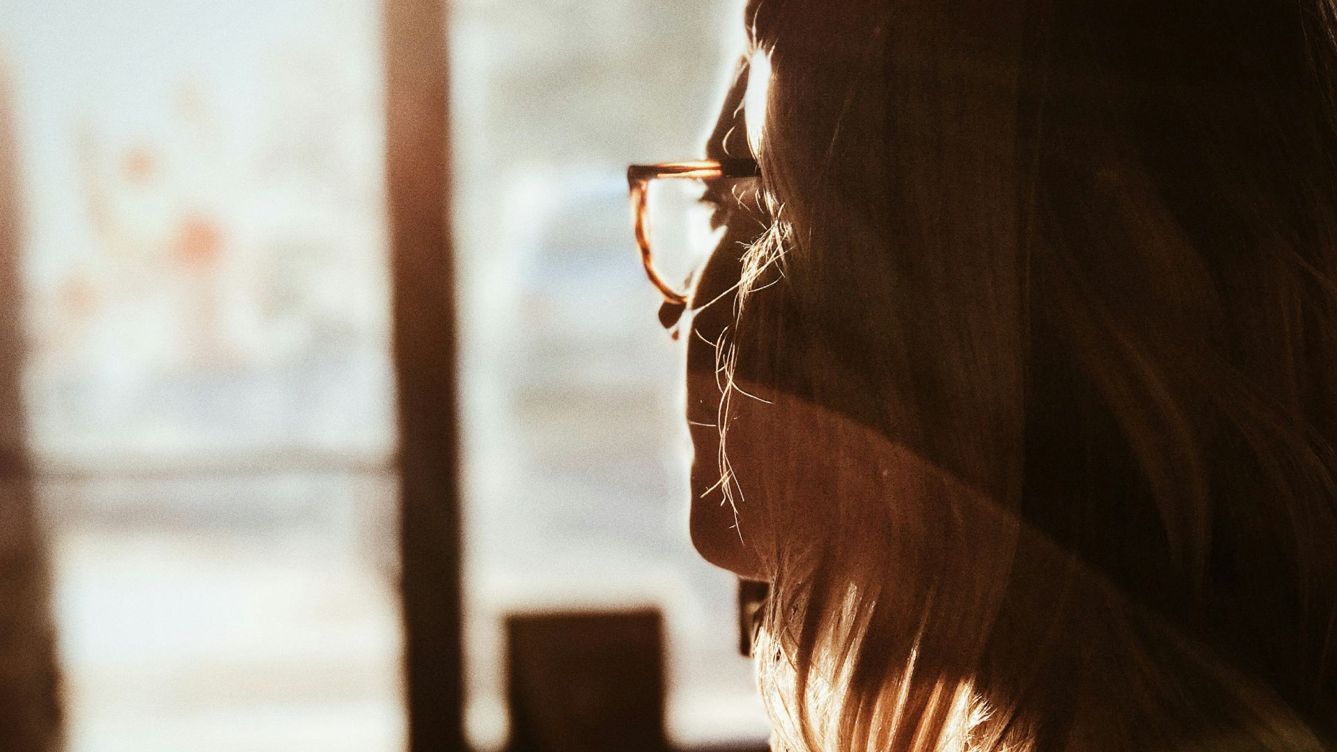 shallow focus photography of woman facing door