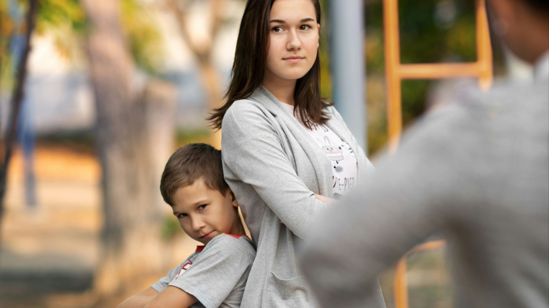 woman in white long sleeve shirt carrying child in white long sleeve shirt