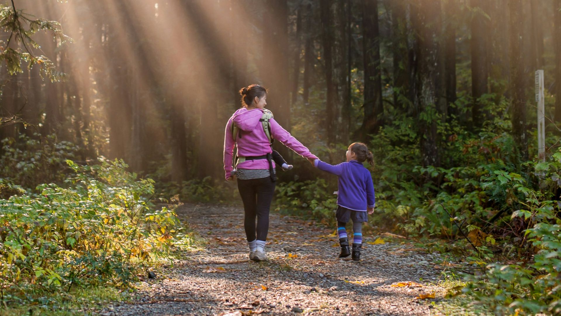 woman walking in forest with child