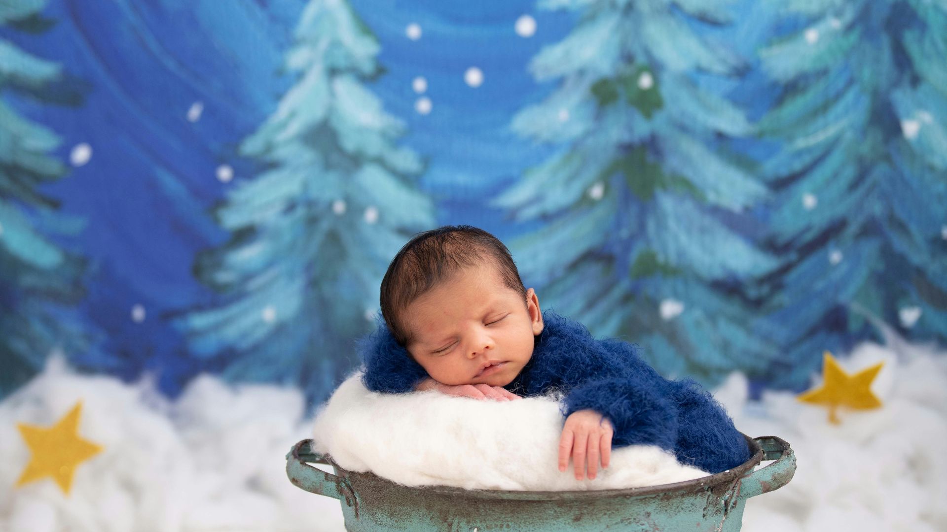 baby in white bucket on snow covered ground