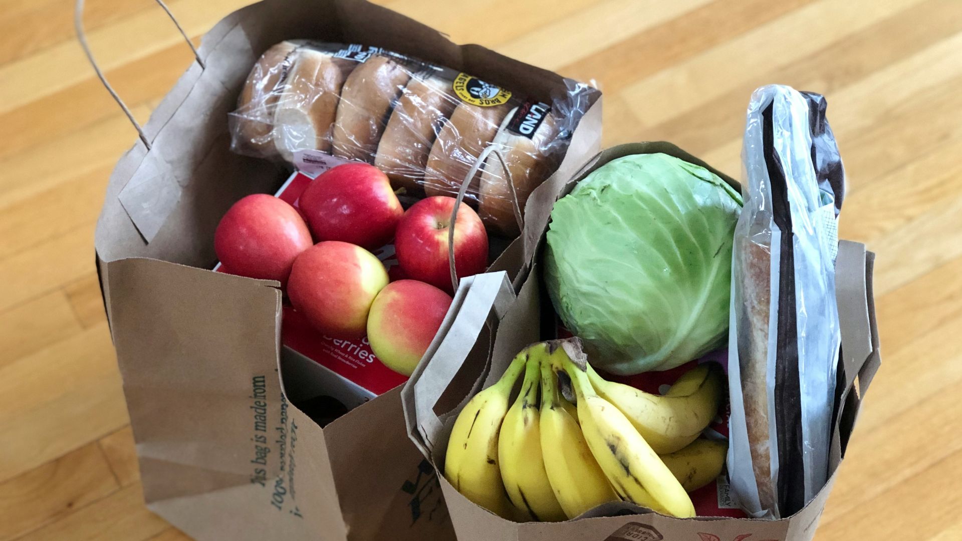 apples and bananas in brown cardboard box