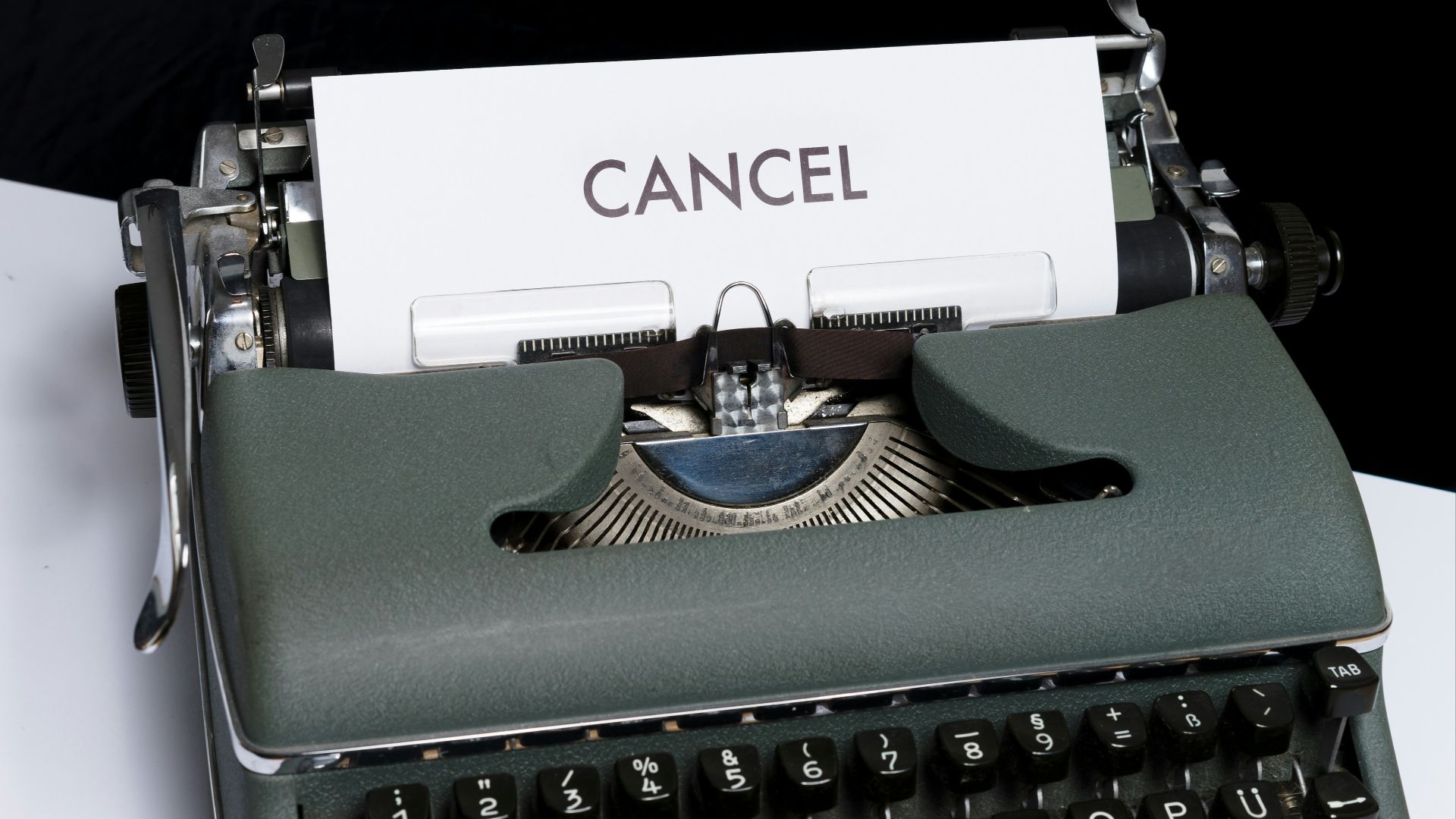 green and white typewriter on black textile