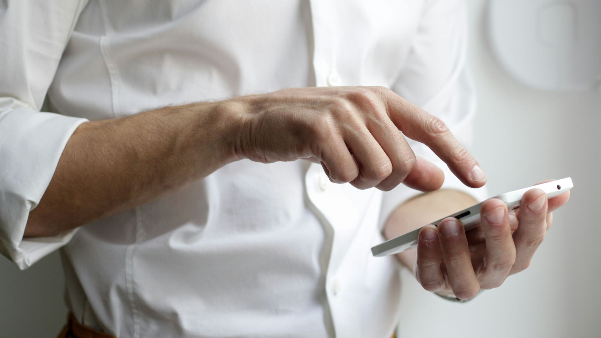 person holding white Android smartphone in white shirt