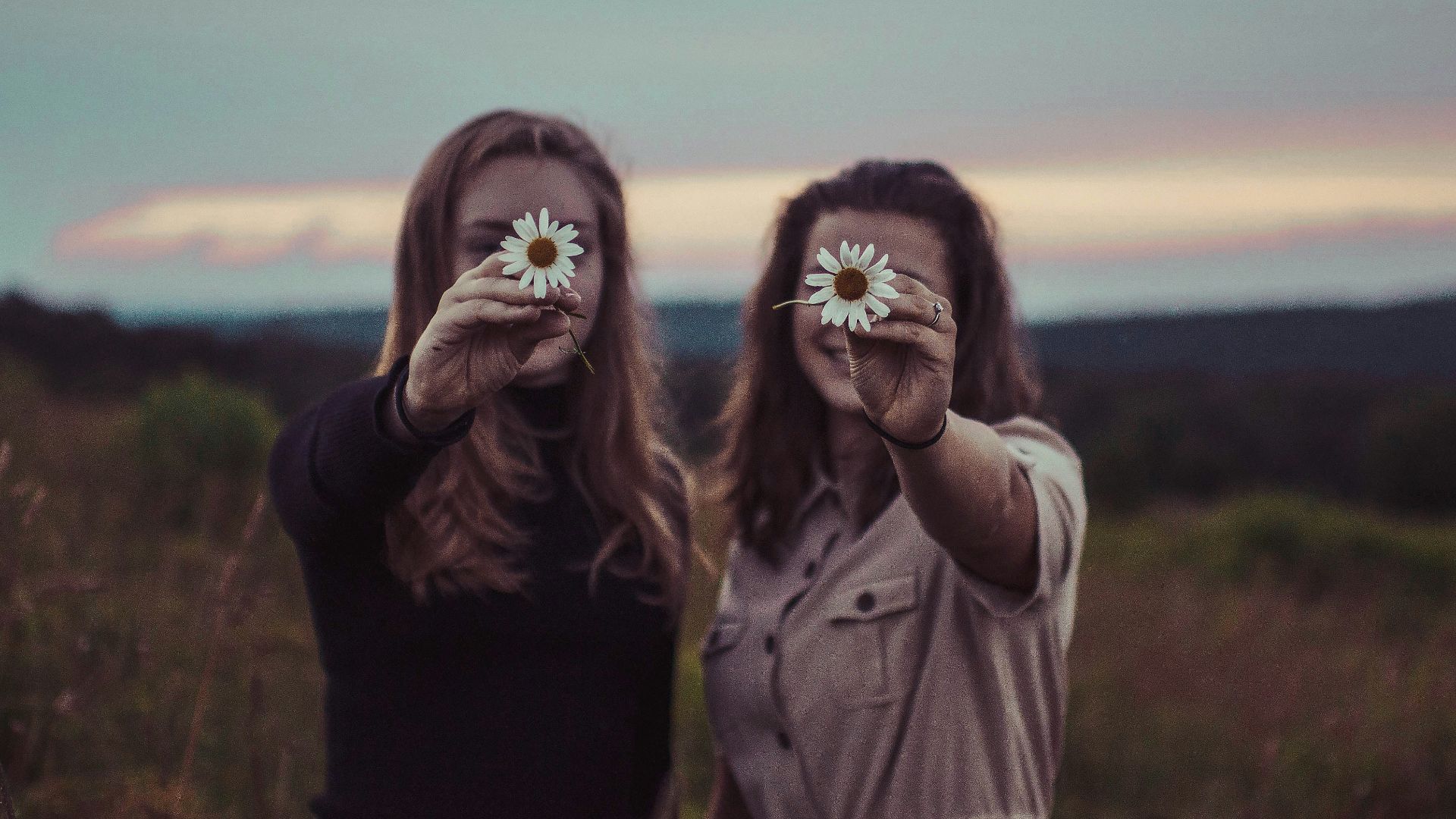 two women holding flowers