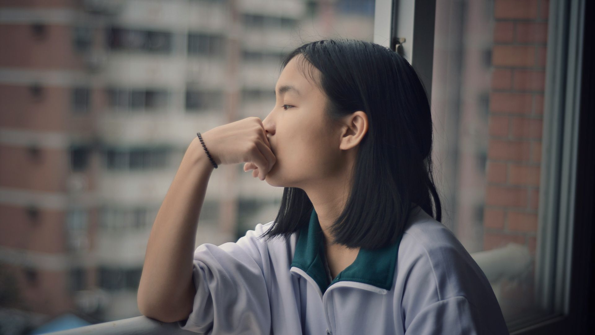 woman looking through window