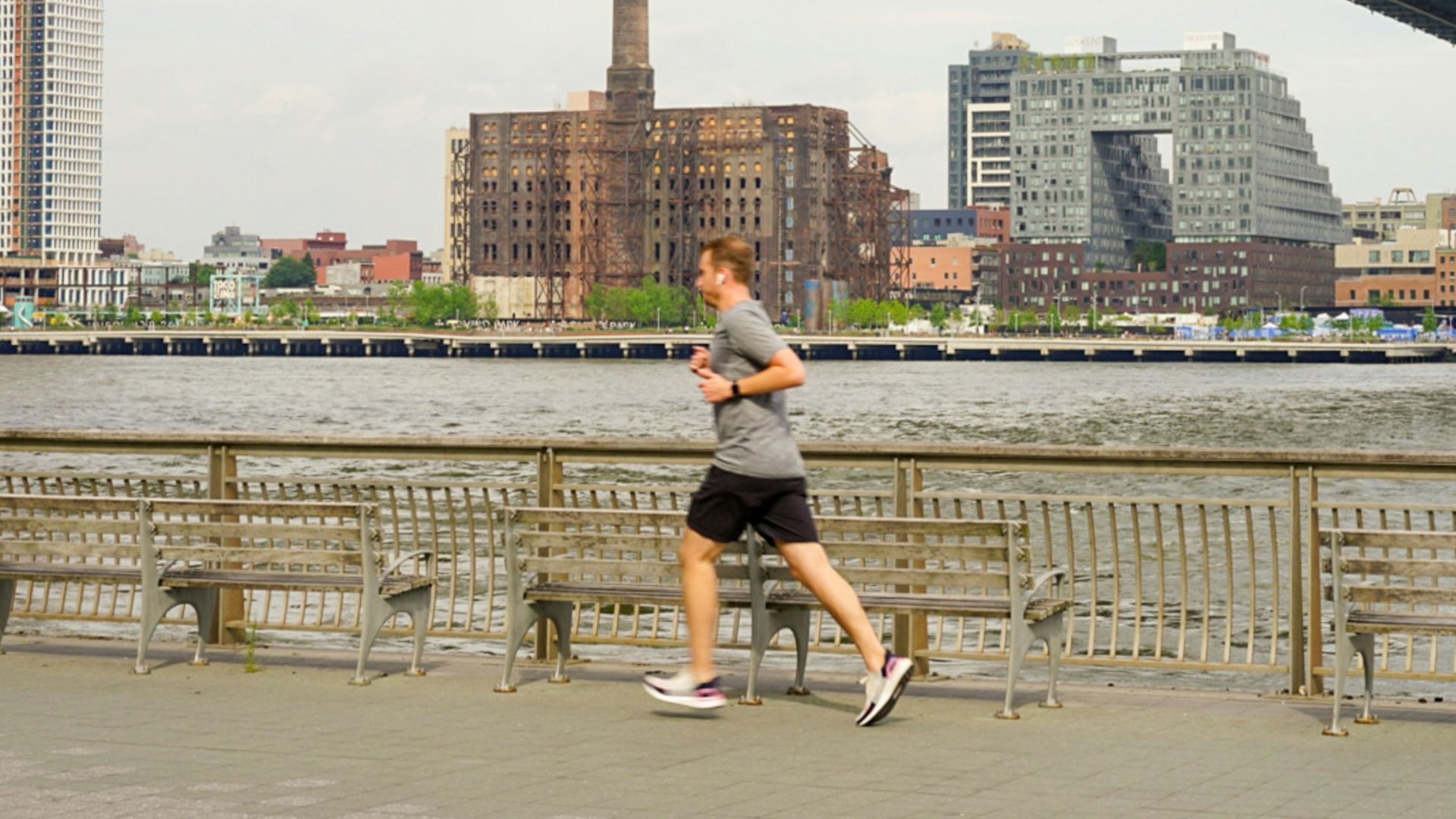 woman running under bridge during daytime