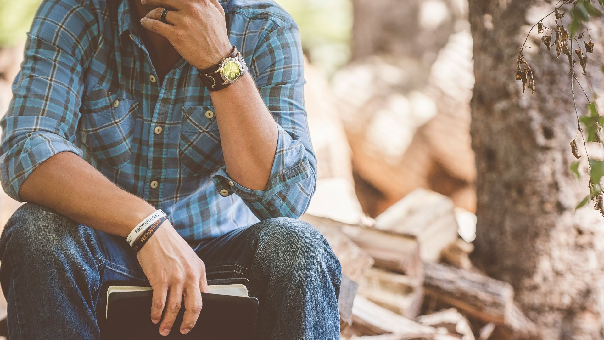 man wearing blue plaid dress shirt and blue jeans