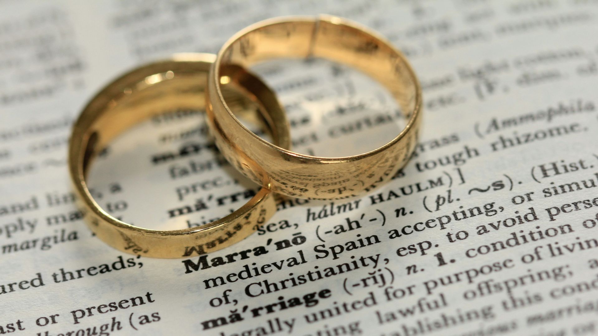 two gold-colored rings on paper