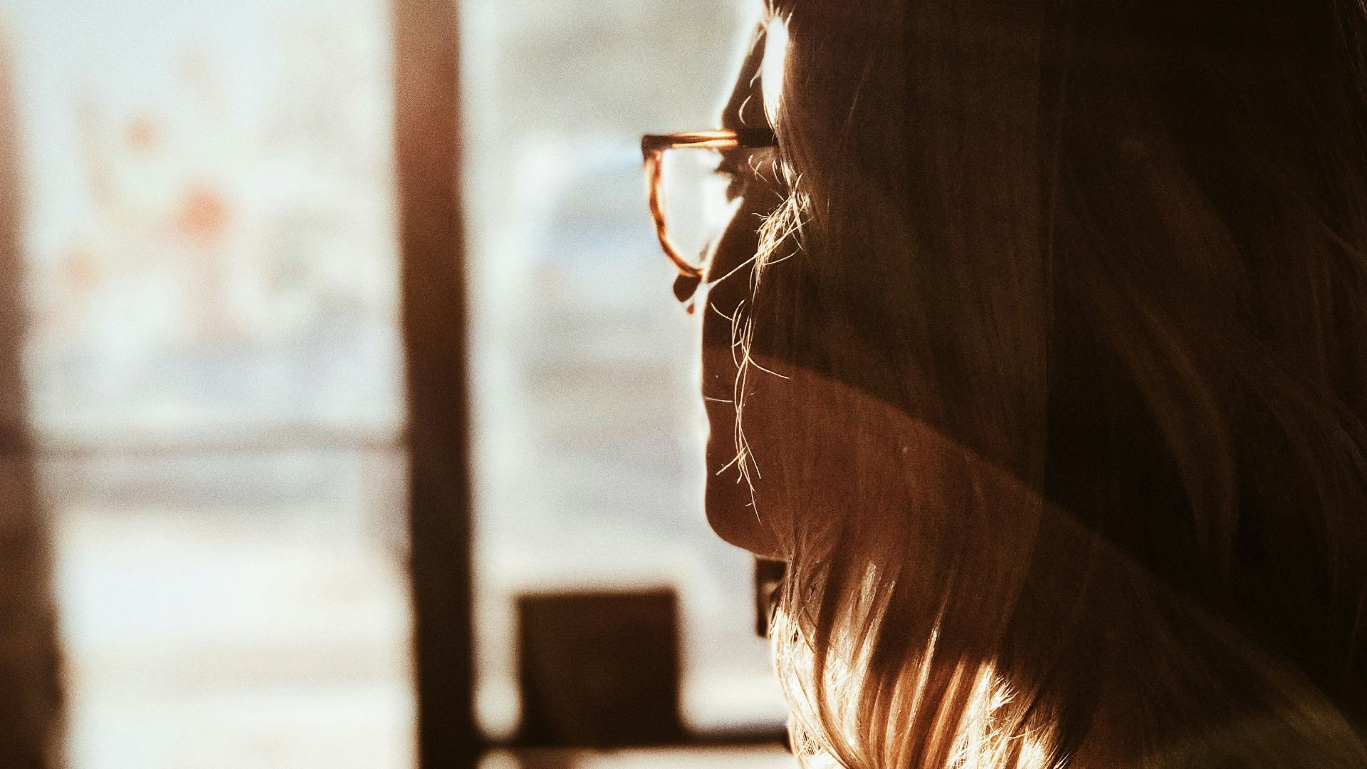 shallow focus photography of woman facing door
