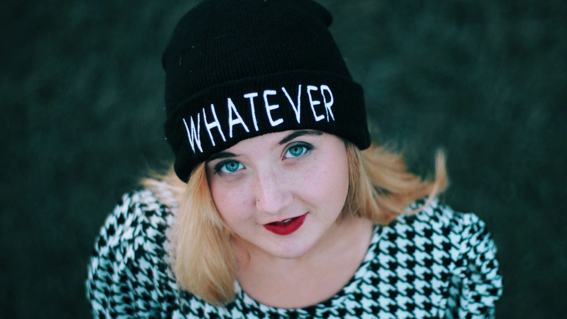 smiling woman wearing black knit cap