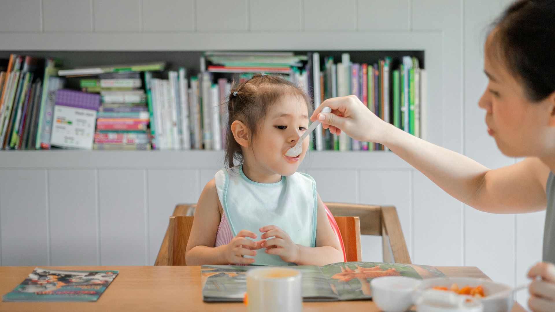 woman holding white plastic spoon