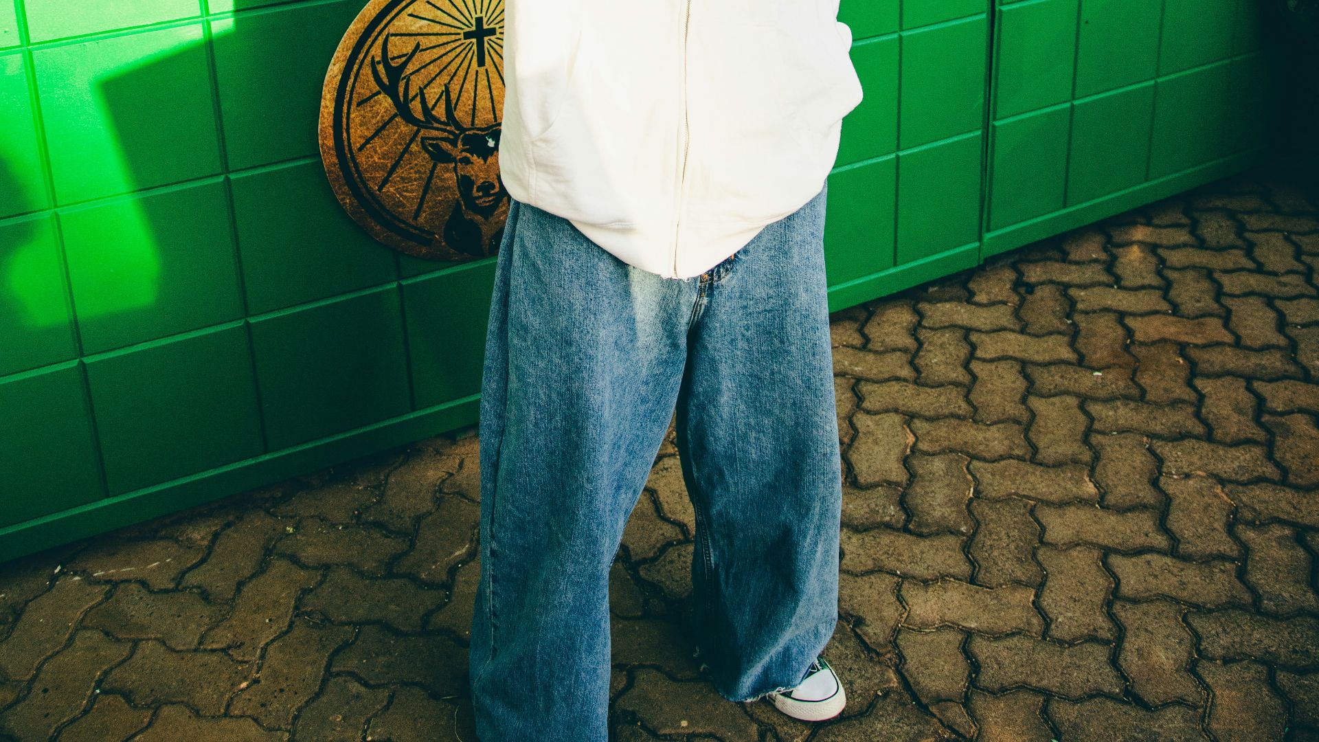 A man is standing in front of a store