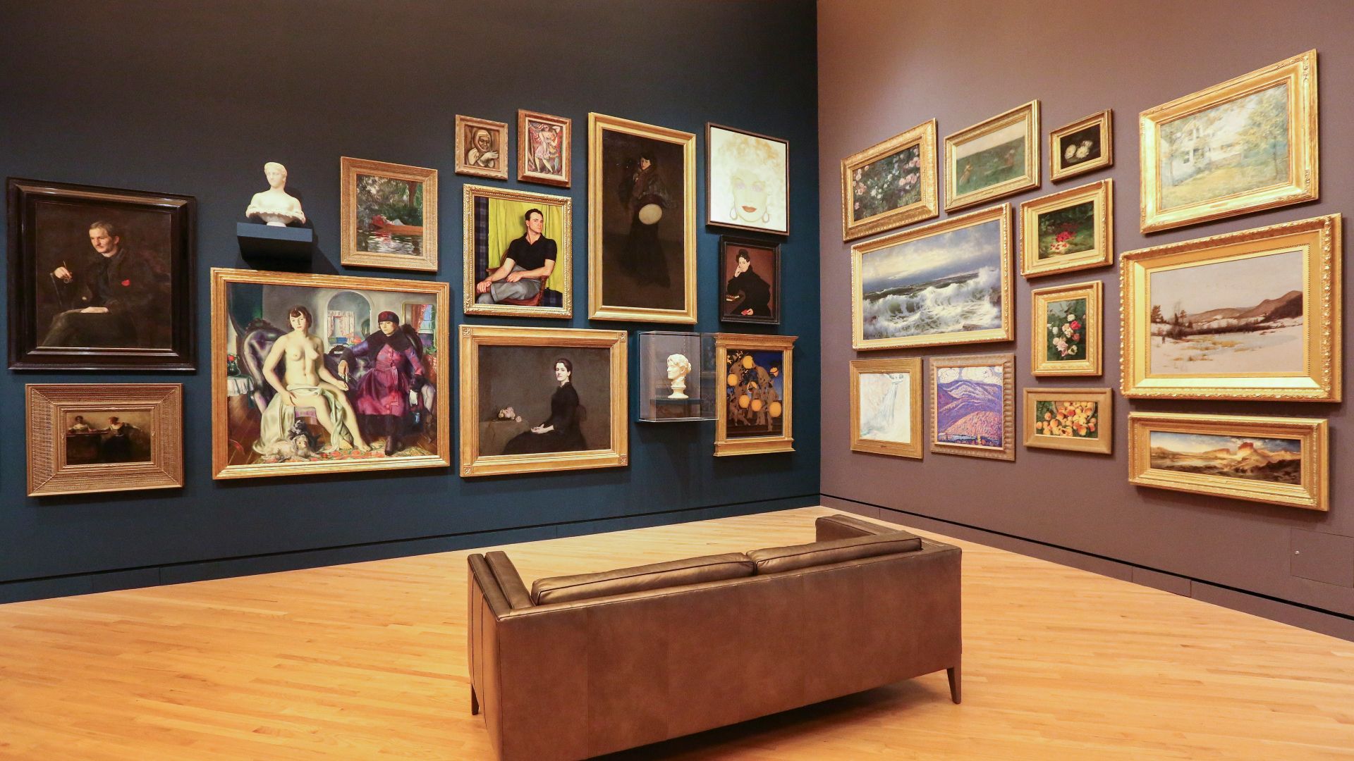 brown loveseat surrounded by photo frame lot