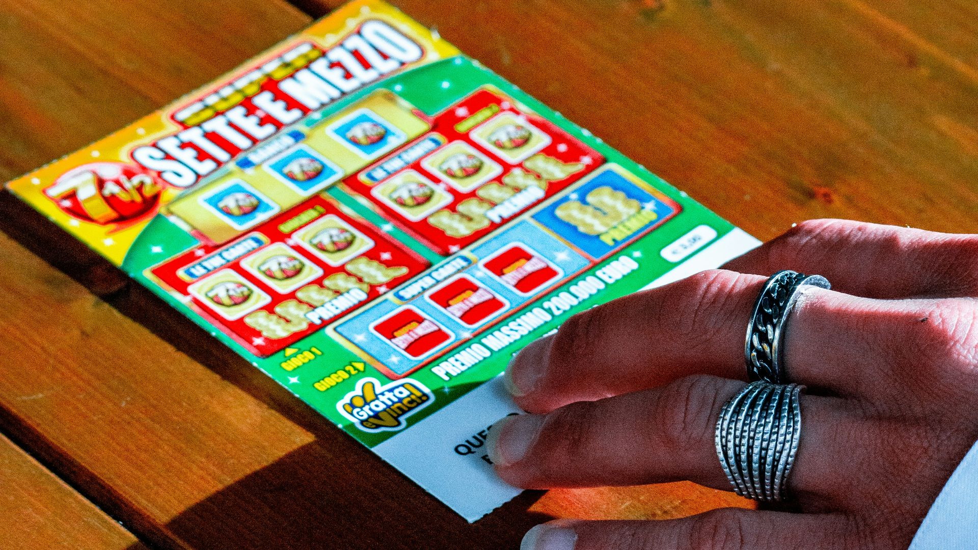 person in white long sleeve shirt holding white and red box