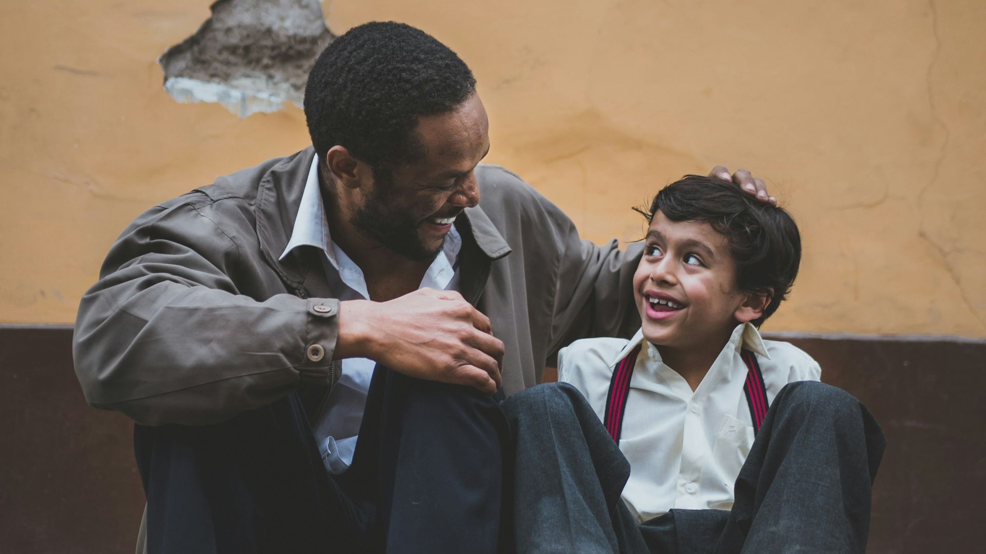 man holding boy's head