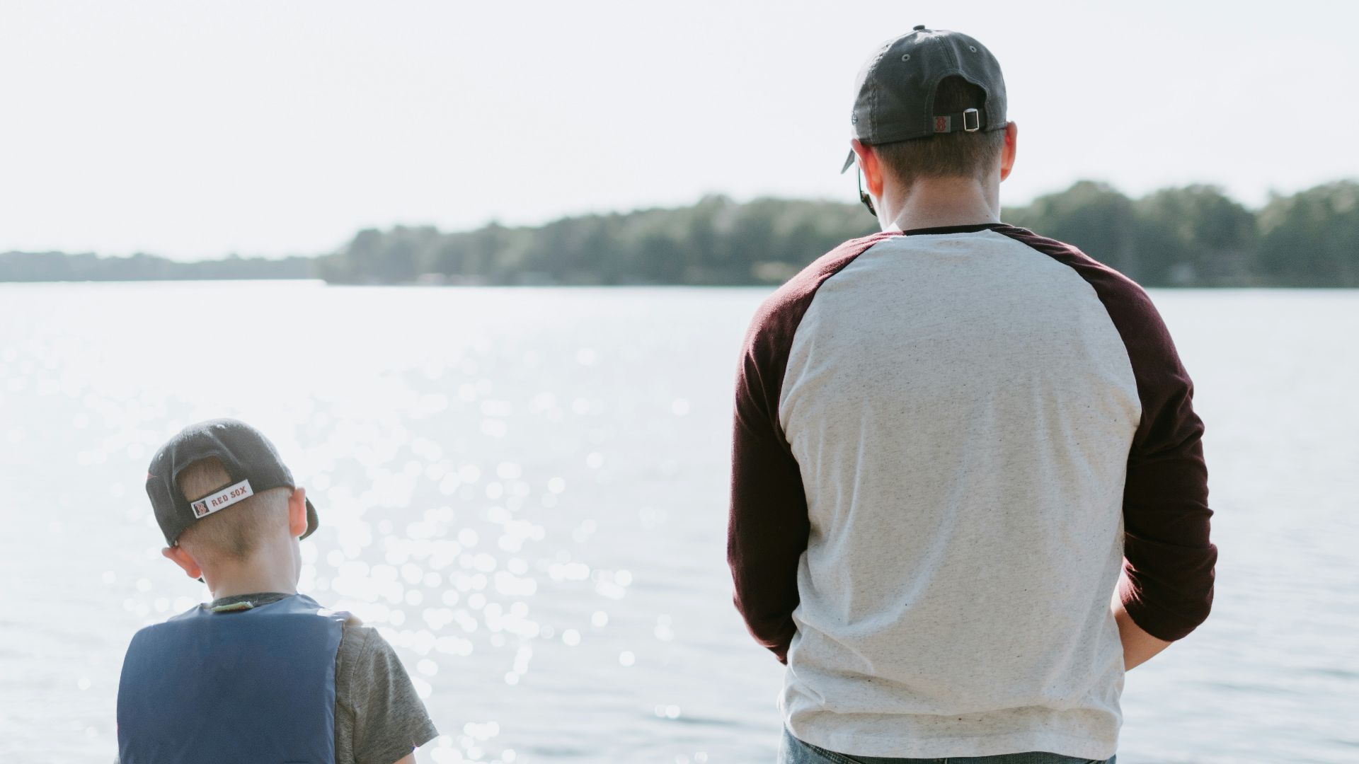 man and boy fishing on water