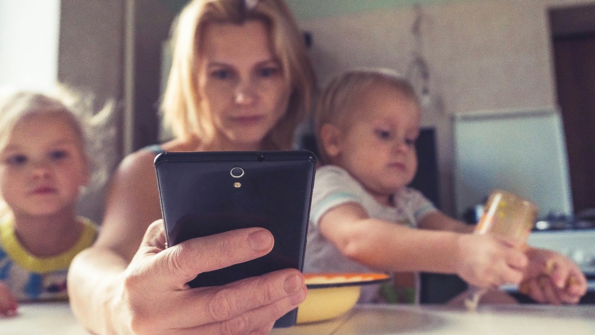 woman in white shirt holding black ipad