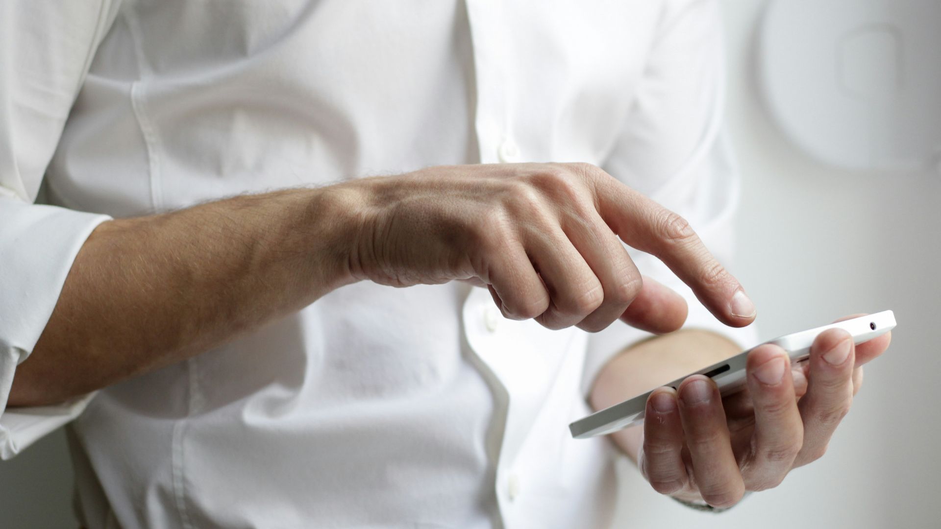 person holding white Android smartphone in white shirt