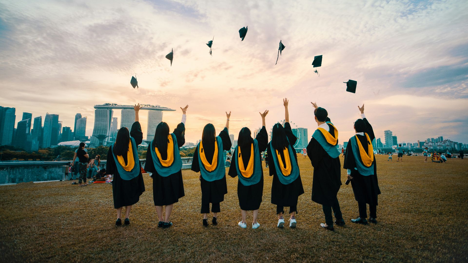 people throwing hats on air