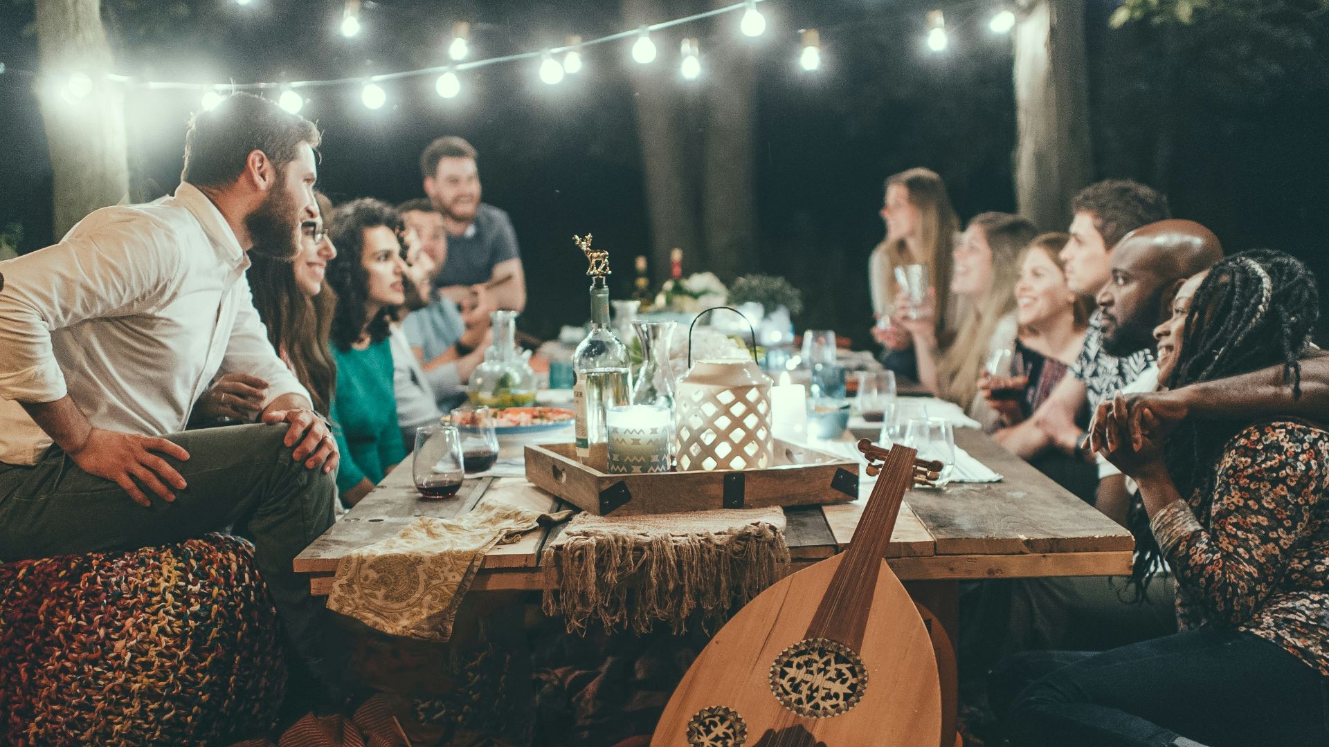 people sitting on chair in front of table with candles and candles