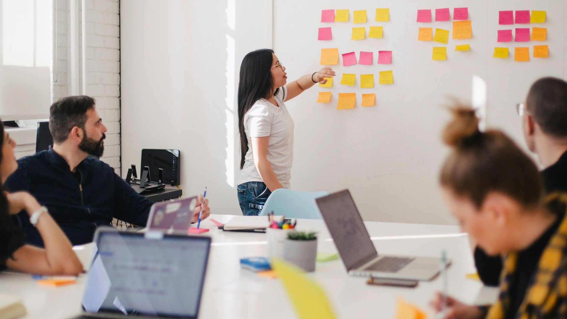 woman placing sticky notes on wall
