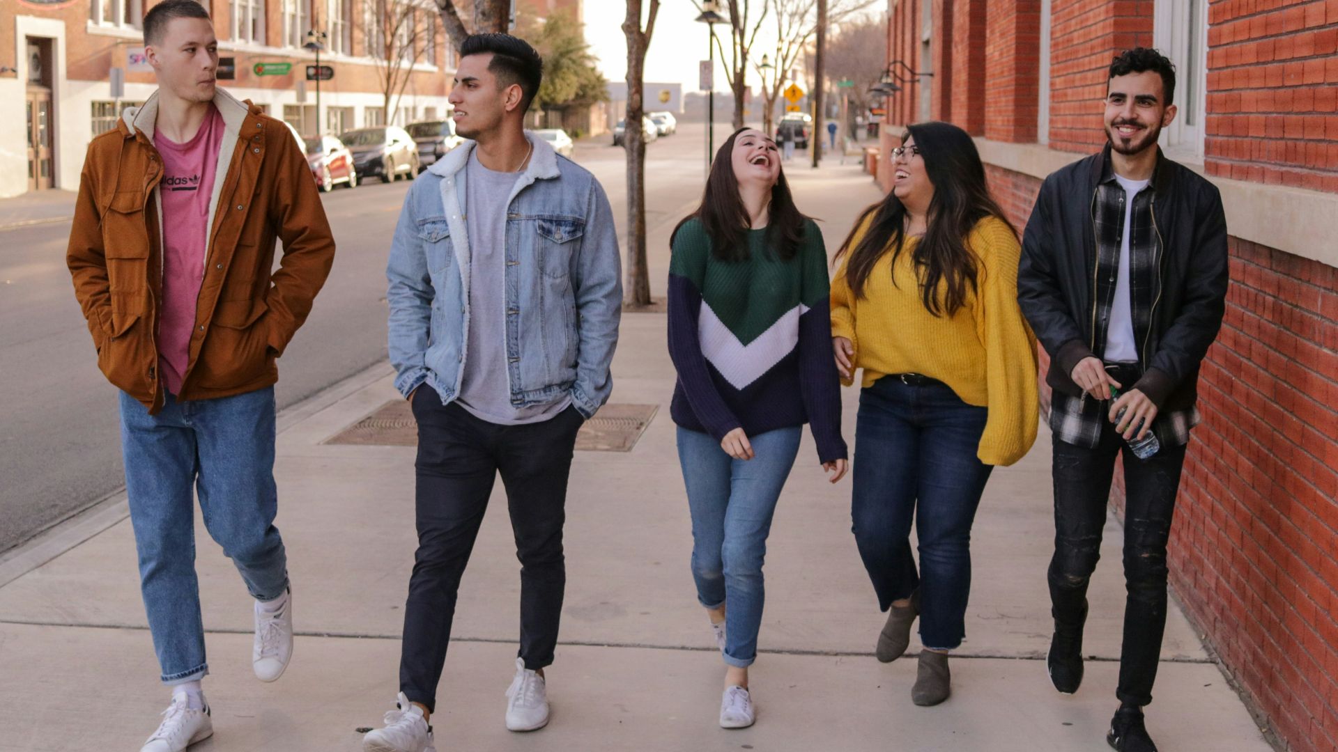 three men and laughing two women walking side by side