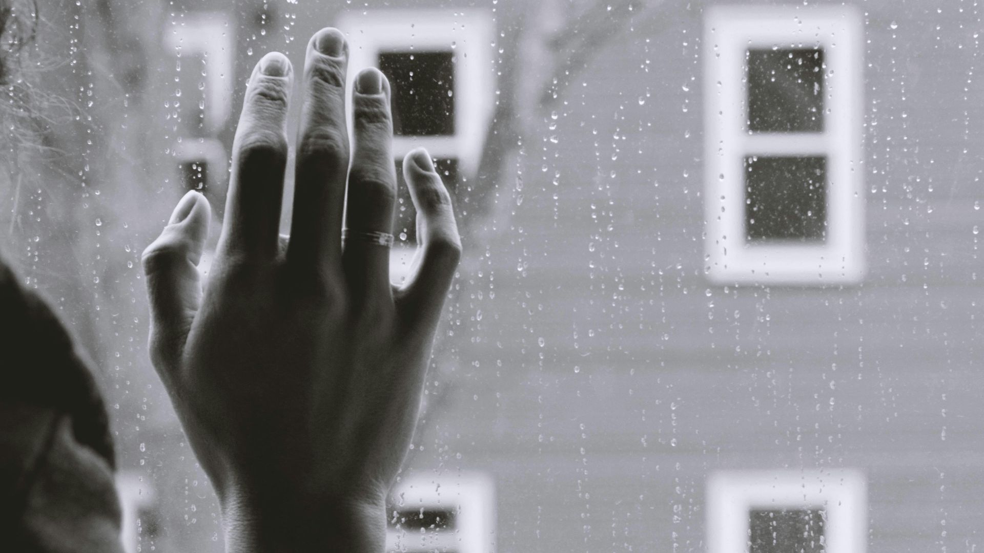 grayscale photo of woman right hand on glass
