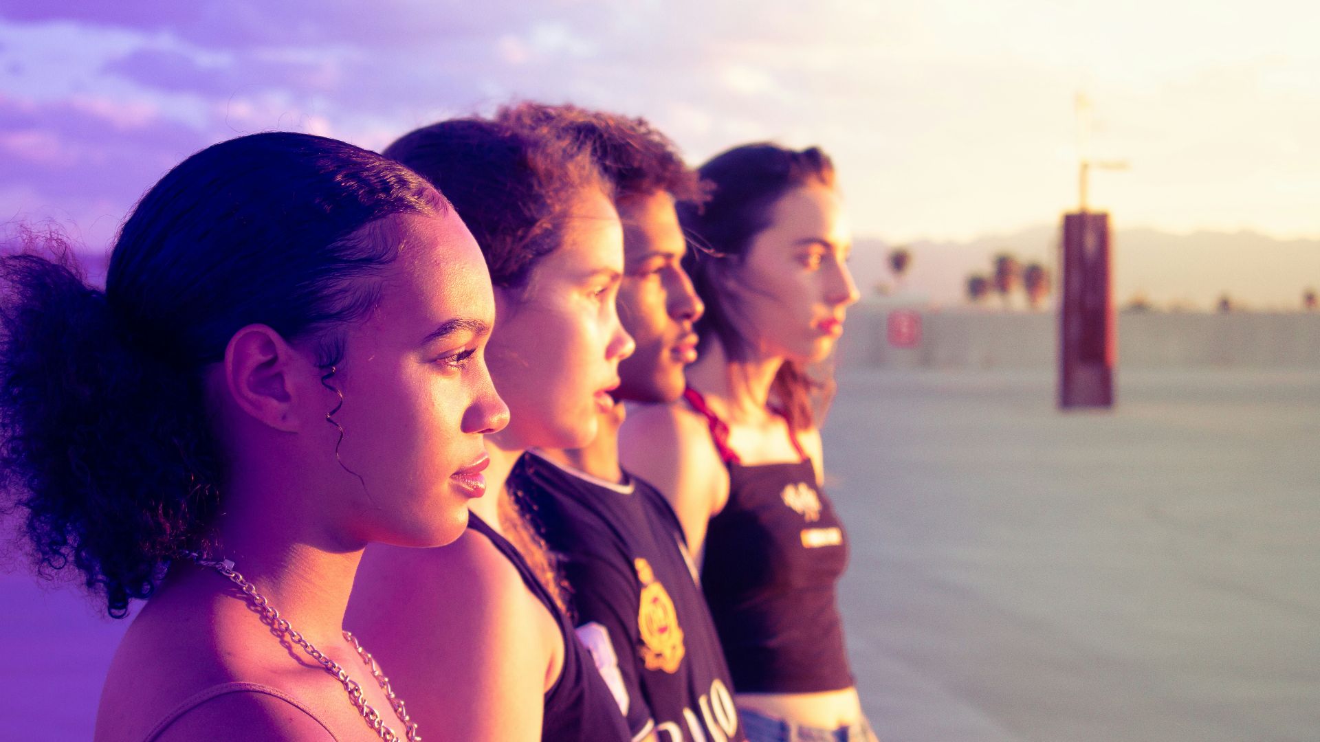 four women standing on pathway looking side