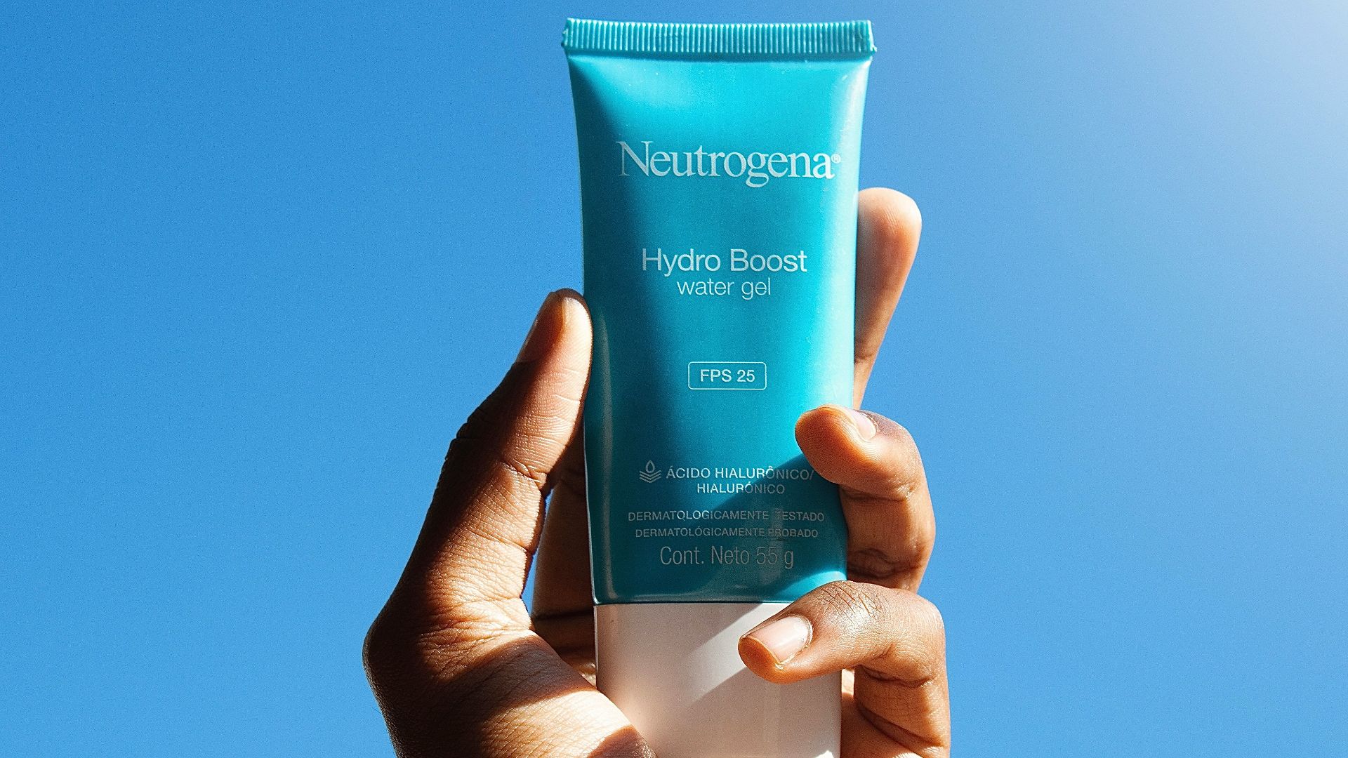 person holding blue and white tube bottle