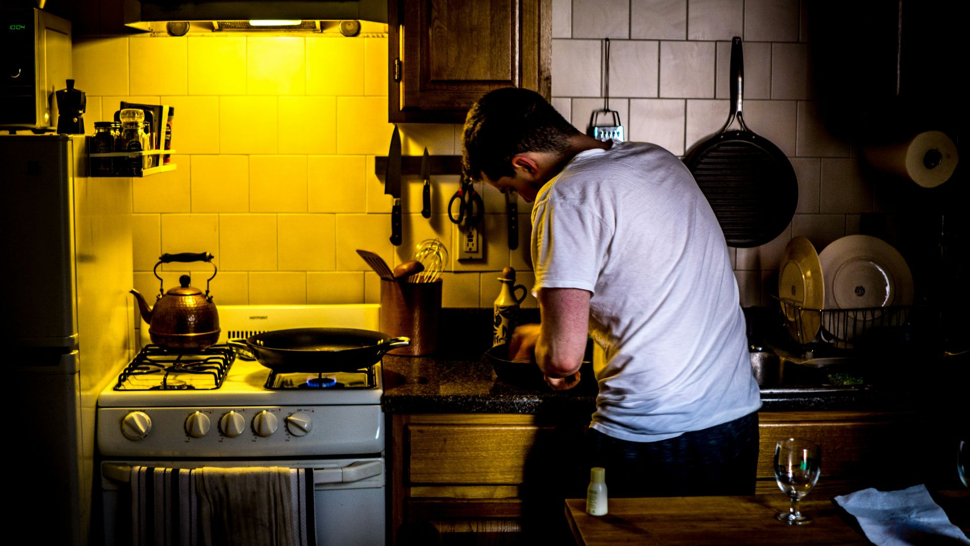 man standing beside range oven
