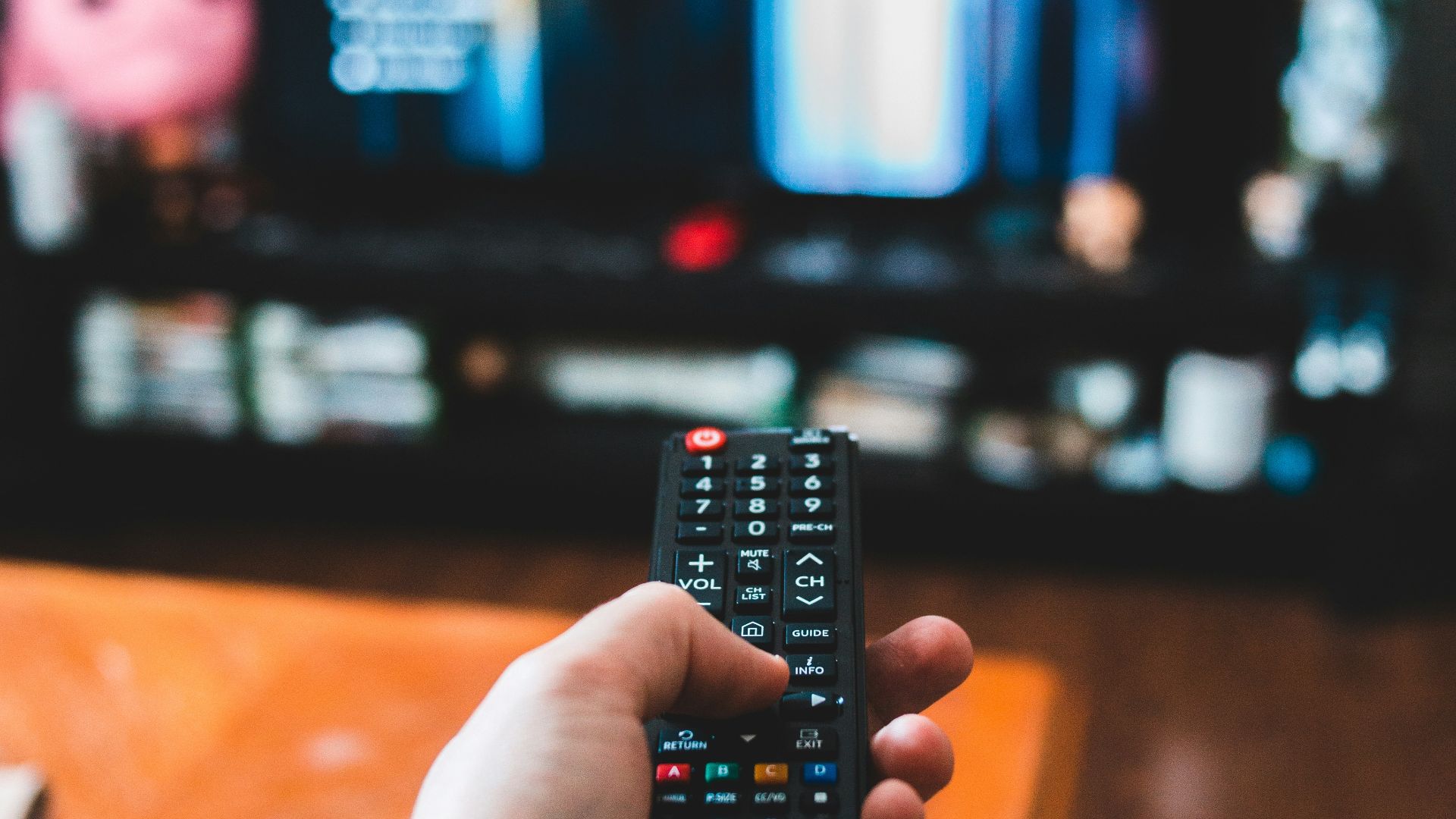 person holding black remote control