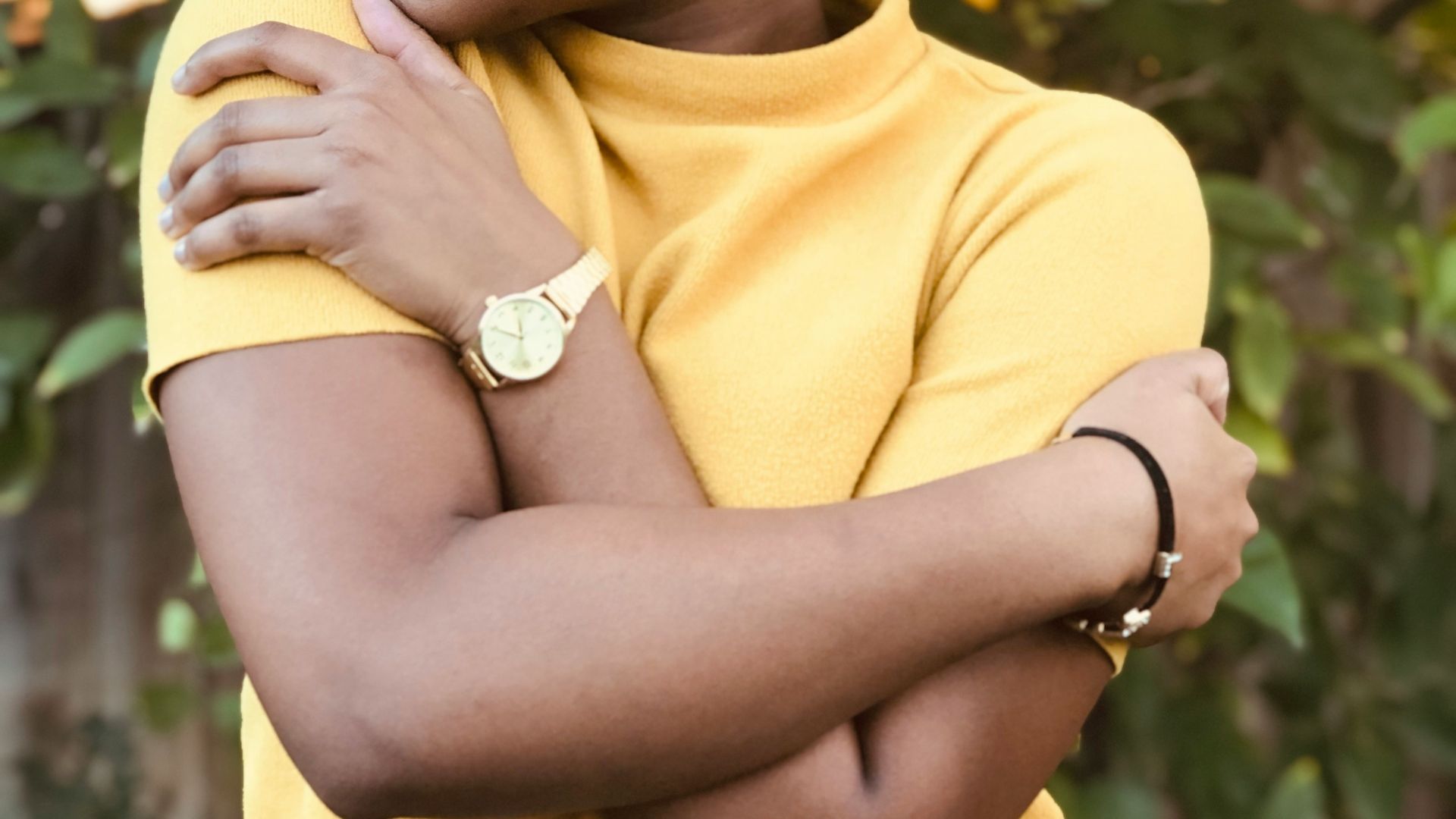 woman in yellow shirt holding yellow fruit