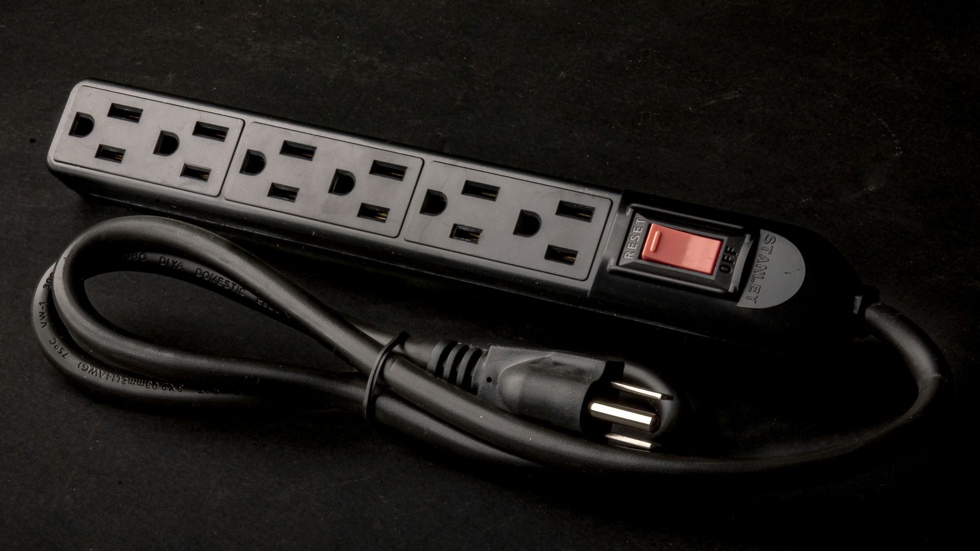 a black power strip sitting on top of a table