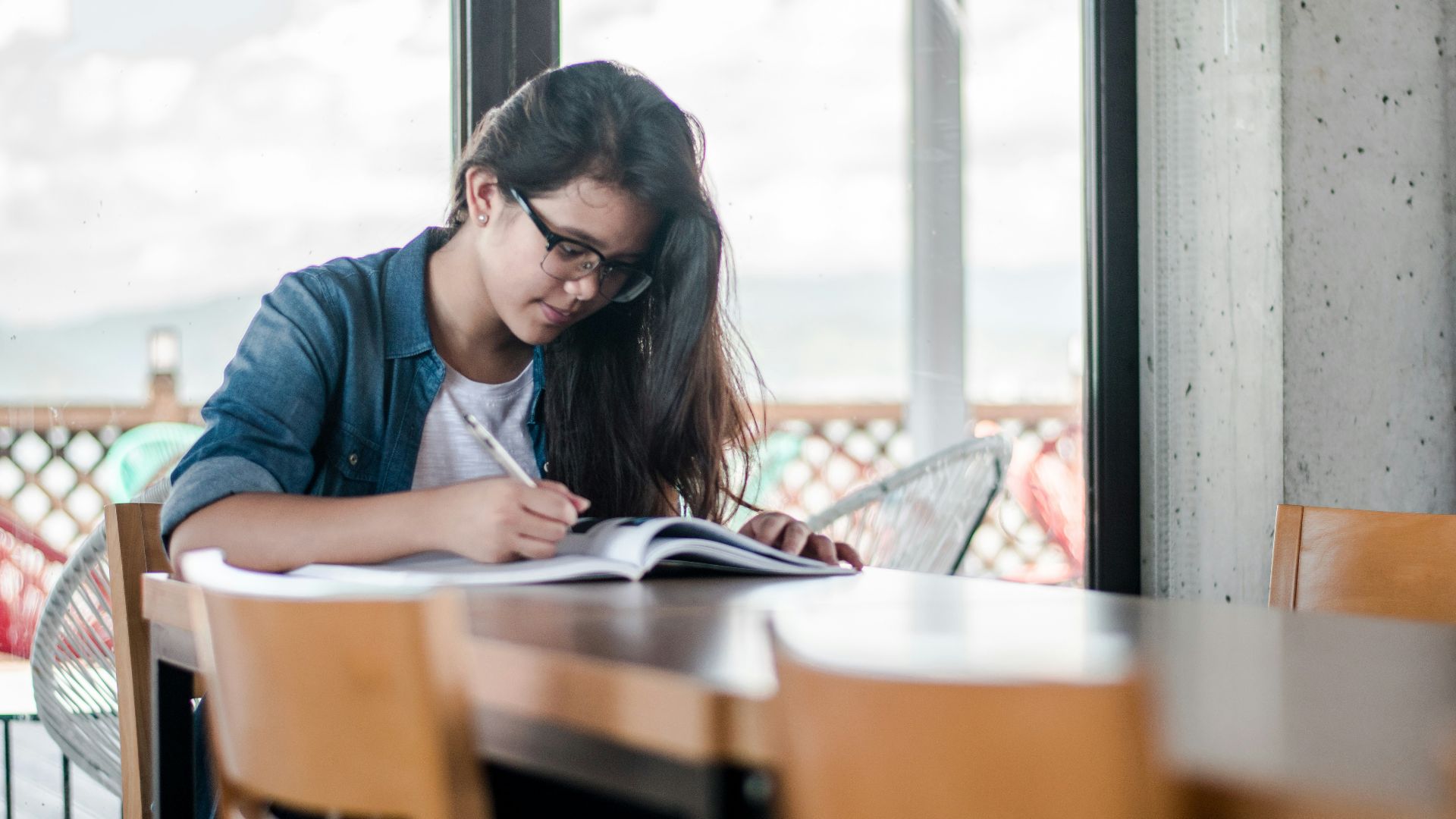 woman writing on book