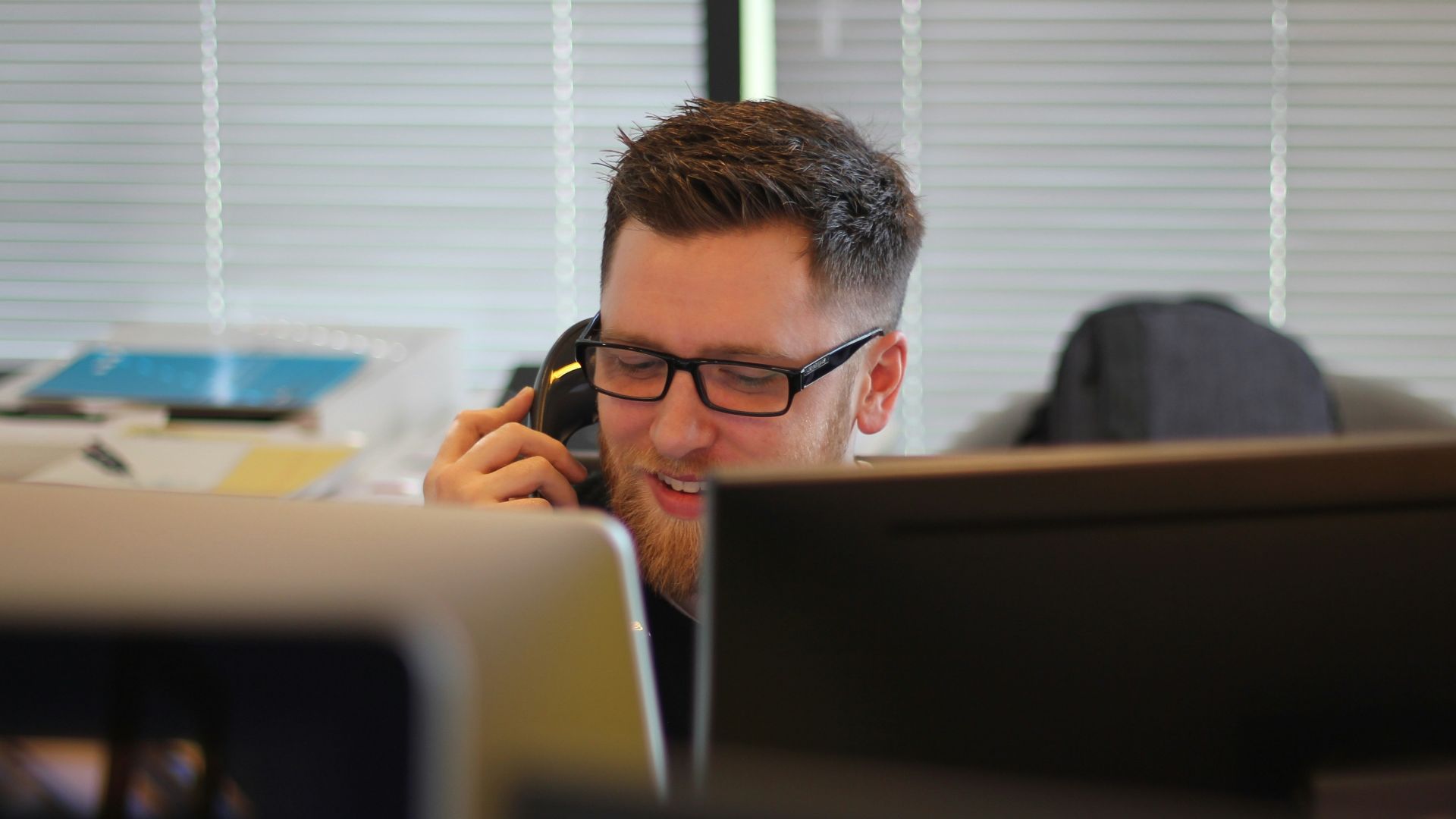 man using IP phone inside room