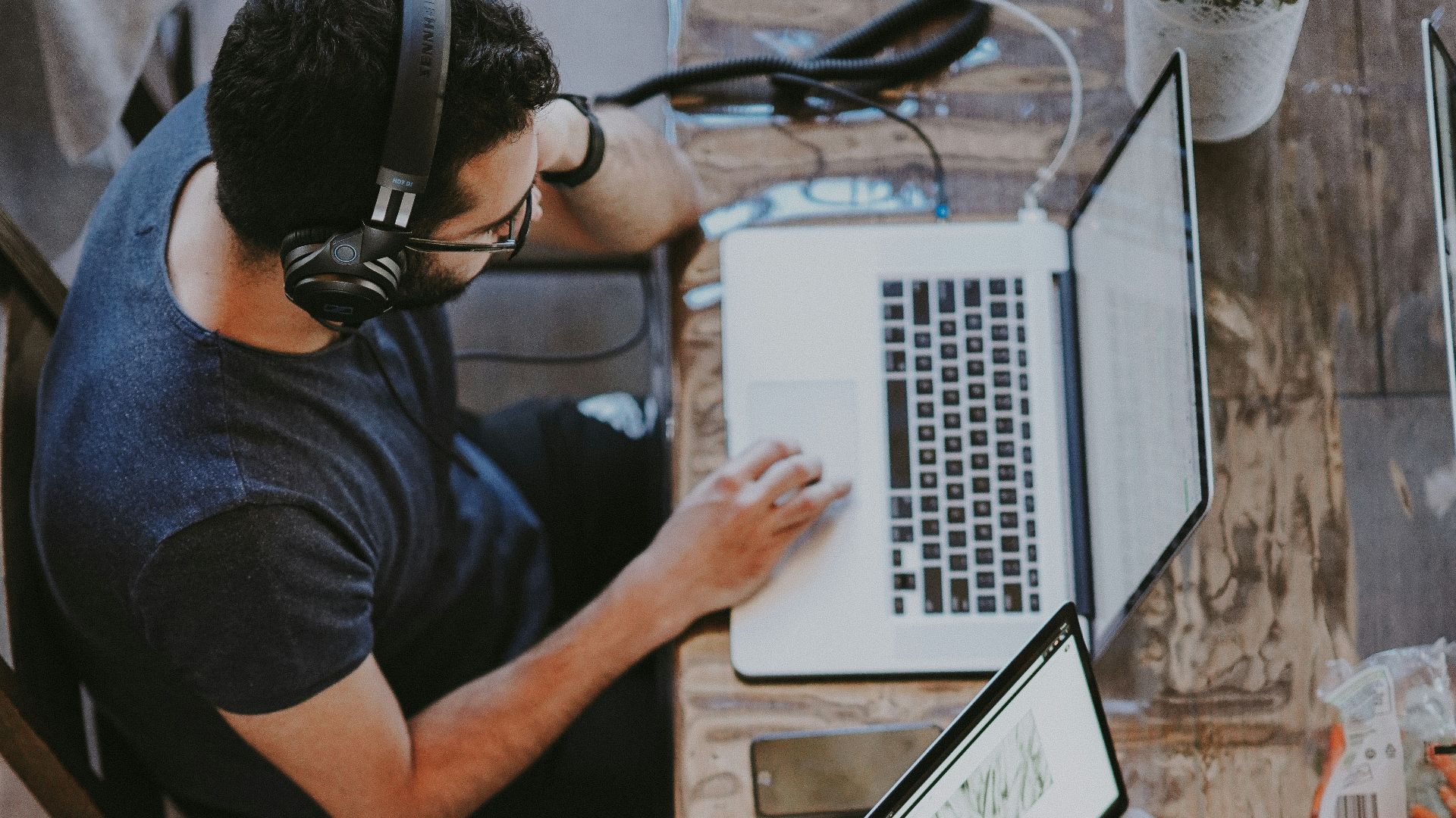 man sitting on chair and looking laptop computer