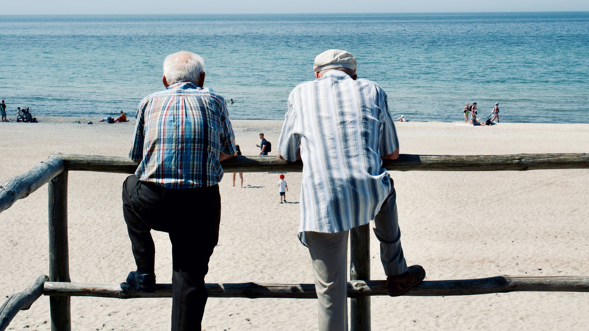 man and woman standing on beach during daytime