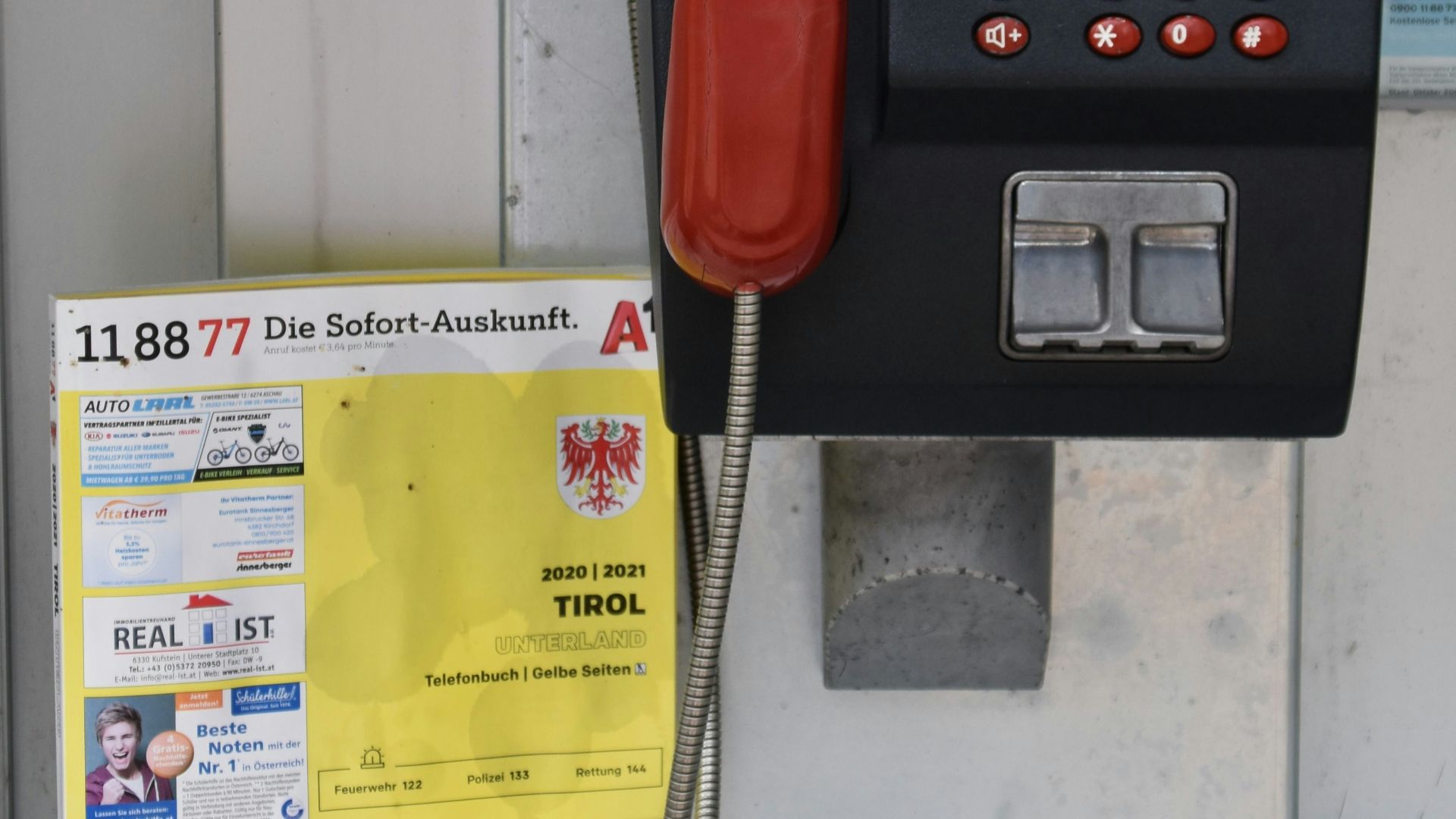red telephone on yellow paper