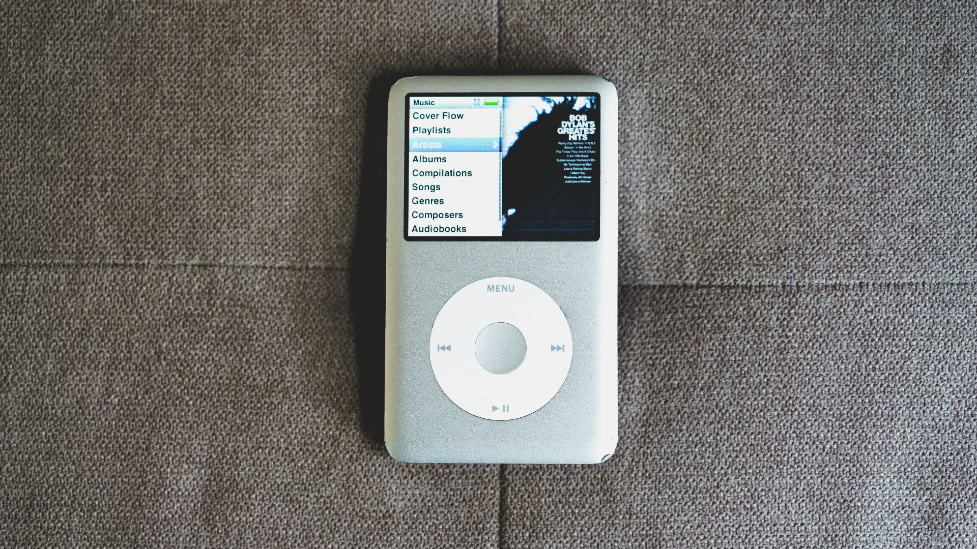 an ipod sitting on top of a couch