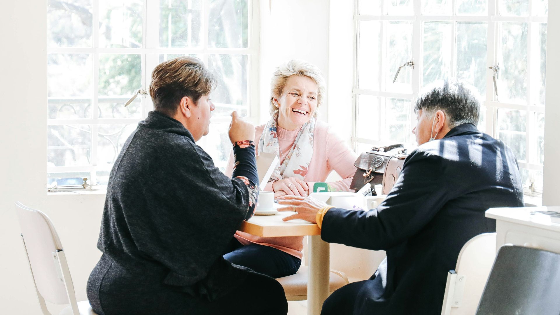 a group of people sitting around a table