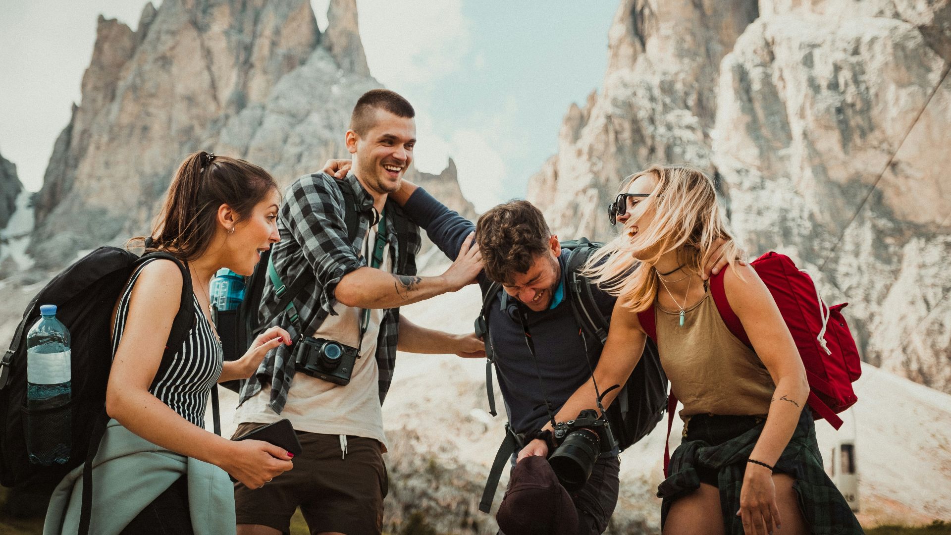 low-angle photography of two men playing beside two women