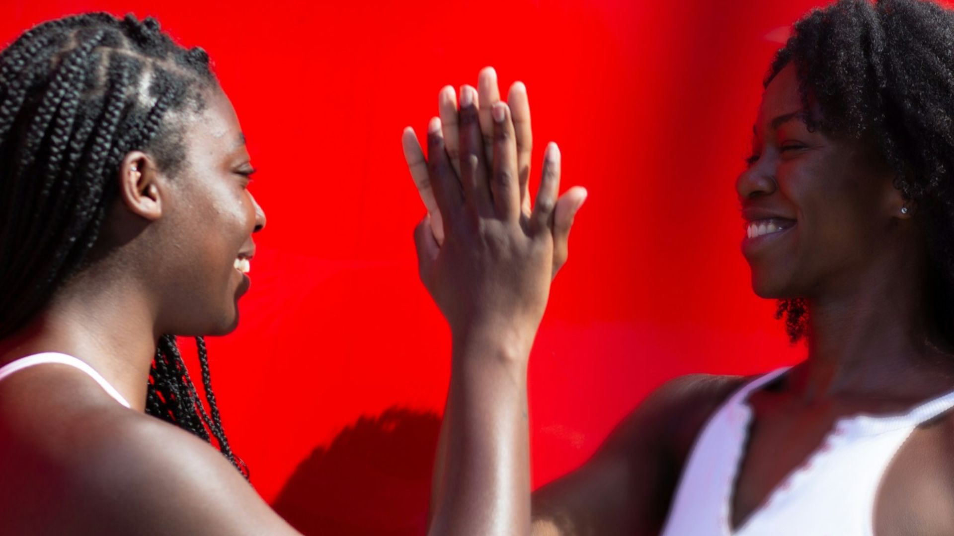 woman in white tank top holding microphone
